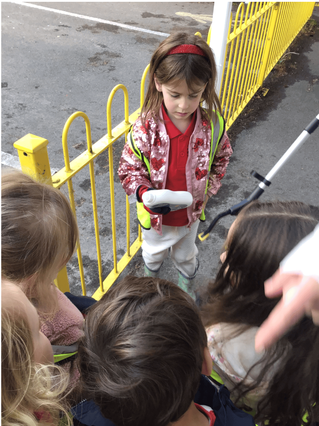 Preschool girl collecting rubbish