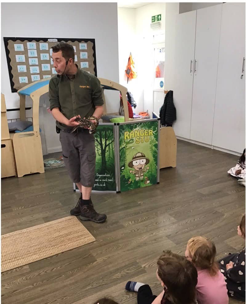 Ranger Stu talking to children holding a snake.png