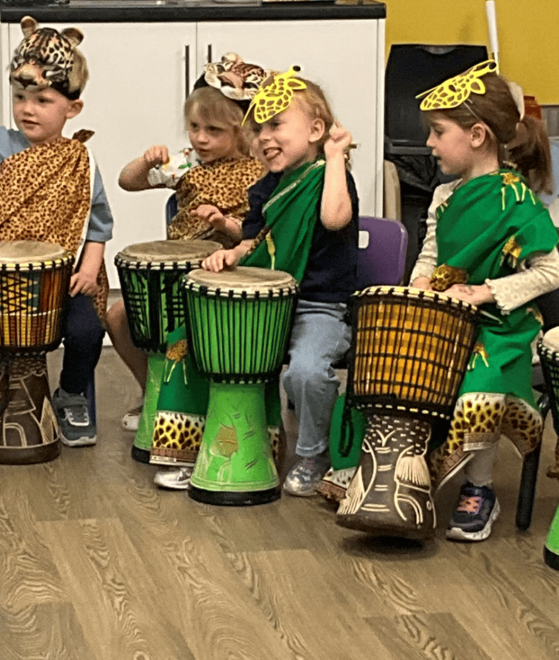 Children having fun playing African drums