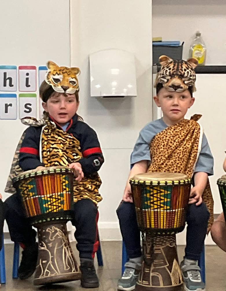 Two boys playing the African drums