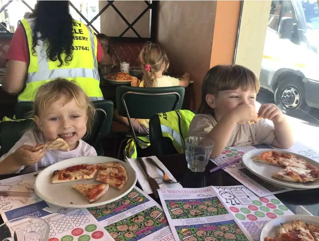 Two girls eating pizza at Pizza Express
