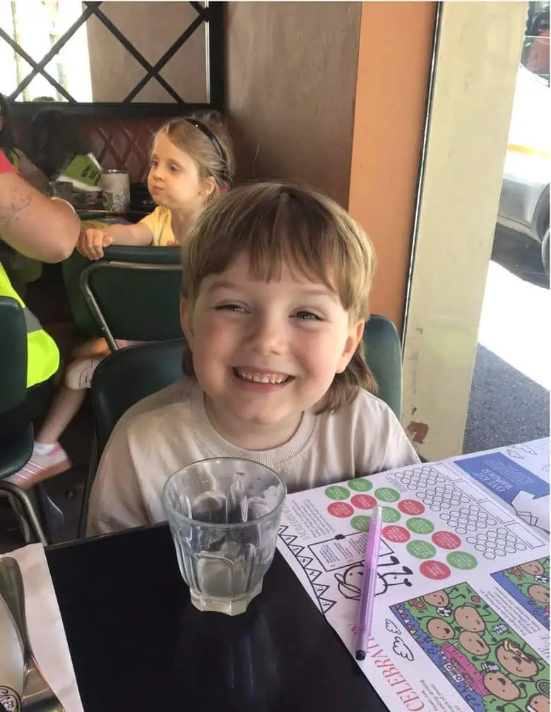 Young child smiling at Pizza Express